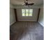 This bedroom features a ceiling fan and a view of the yard at 1460 Hartford Sw Ave, Atlanta, GA 30310