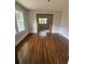 This dining room has wood floors and a doorway to the bedroom at 1460 Hartford Sw Ave, Atlanta, GA 30310
