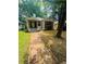Quaint cottage-style home with white brick, fresh green lawn, beautiful wood design and updated landscaping, creating curb appeal at 1460 Hartford Sw Ave, Atlanta, GA 30310