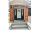 A beautifully designed front porch with stylish wood columns, modern lighting fixtures, and a freshly painted front door at 1460 Hartford Sw Ave, Atlanta, GA 30310