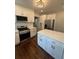Modern kitchen boasting new appliances, white cabinets, quartz countertops, stylish hardware, and dark hardwood floors at 1460 Hartford Sw Ave, Atlanta, GA 30310