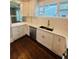 Bright kitchen featuring white cabinetry, stainless steel appliances, and a large window overlooking the backyard at 1460 Hartford Sw Ave, Atlanta, GA 30310