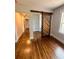 Living Room features barn door, hardwood flooring, and a large window at 1460 Hartford Sw Ave, Atlanta, GA 30310