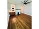 Spacious living room featuring beautiful hardwood floors, stylish ceiling fan, and a decorative fireplace creating inviting ambiance at 1460 Hartford Sw Ave, Atlanta, GA 30310