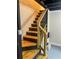 Basement staircase with wooden steps, black railing, and painted walls at 1460 Hartford Sw Ave, Atlanta, GA 30310