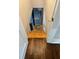 A view down the wooden staircase to the lower level with safety gate at 1460 Hartford Sw Ave, Atlanta, GA 30310