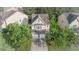 A high-angle view of a two-story home with a two-car garage surrounded by lush trees at 4350 Annlette Dr, Lawrenceville, GA 30044