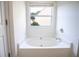 Clean and simple bathtub set against a window at 4350 Annlette Dr, Lawrenceville, GA 30044