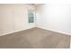 Cozy bedroom featuring neutral carpet, a window with natural light, and ample space for relaxation at 4350 Annlette Dr, Lawrenceville, GA 30044