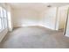 Spacious bedroom with neutral carpet, white walls, and a large window at 4350 Annlette Dr, Lawrenceville, GA 30044