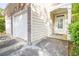Exterior featuring a two-car garage and a covered front porch entrance, complemented by lush landscaping at 4350 Annlette Dr, Lawrenceville, GA 30044