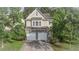Charming two-story home featuring a stone-accented facade, two-car garage, and lush landscaping at 4350 Annlette Dr, Lawrenceville, GA 30044