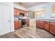 Well-lit kitchen featuring wood cabinets, stainless steel appliances, and wood-look flooring at 4350 Annlette Dr, Lawrenceville, GA 30044