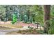 Playground at Chosewood Park featuring green slides and climbing structures, surrounded by shady trees at 511 Casanova Se St, Atlanta, GA 30315
