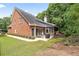 Spacious backyard featuring a lush lawn, mature trees, and patio with furniture at 13995 Mariners Cv, Alpharetta, GA 30005