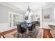 Elegant dining room features a glass top table, wood floors, shutters, and a mirror wall at 13995 Mariners Cv, Alpharetta, GA 30005