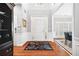 Inviting foyer with hardwood floors, wainscoting, neutral walls and a view into the dining room at 13995 Mariners Cv, Alpharetta, GA 30005