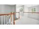 Upstairs hallway featuring wood trim, natural lighting, and neutral carpeting at 13995 Mariners Cv, Alpharetta, GA 30005