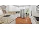 Bright kitchen with stainless steel appliances, granite countertops, and hardwood floors at 13995 Mariners Cv, Alpharetta, GA 30005