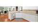 Lovely kitchen featuring stainless steel appliances, light countertops and wood floors at 13995 Mariners Cv, Alpharetta, GA 30005