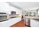 Well-equipped kitchen with stainless steel appliances, white cabinetry, and light countertops at 13995 Mariners Cv, Alpharetta, GA 30005