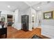 Spacious living area with hardwood floors, neutral walls, and view of a staircase and back hallway at 13995 Mariners Cv, Alpharetta, GA 30005