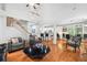 Bright and open living room featuring vaulted ceilings, hardwood floors, and an open view to the kitchen at 13995 Mariners Cv, Alpharetta, GA 30005