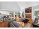 Inviting living space featuring hardwood floors, vaulted ceilings, brick fireplace and an open view to the kitchen at 13995 Mariners Cv, Alpharetta, GA 30005