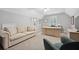 Office space featuring a large desk, sofa and ample natural light at 13995 Mariners Cv, Alpharetta, GA 30005