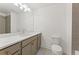 Well-lit bathroom featuring a large vanity with quartz countertop, framed mirror, and walk-in shower at 2410 Glade Overlook, Cumming, GA 30041