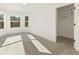Bright, airy bedroom featuring large windows, a tray ceiling, and neutral carpet at 2410 Glade Overlook, Cumming, GA 30041