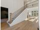 Bright foyer featuring a staircase with metal balusters, hardwood floors, and natural light from large windows at 2410 Glade Overlook, Cumming, GA 30041