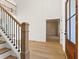 Foyer with hardwood floors, staircase, and a glimpse into the adjacent room with paneled walls at 2410 Glade Overlook, Cumming, GA 30041