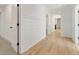 Hallway featuring shiplap accent wall, beautiful wood floors, and modern lighting at 2410 Glade Overlook, Cumming, GA 30041