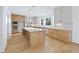 Bright kitchen with a large island, modern appliances, wood floors and a combination of light and dark wood cabinets at 2410 Glade Overlook, Cumming, GA 30041