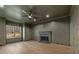 Modern living room with dark green walls, modern fireplace, ceiling fan, and hardwood floors at 2410 Glade Overlook, Cumming, GA 30041