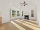 Bright and airy living room with high vaulted ceiling, fireplace, hardwood floors and lots of natural light from windows at 2410 Glade Overlook, Cumming, GA 30041