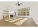 Open-concept living area with high ceilings, fireplace, built-ins, hardwood floors, and lots of natural light at 2410 Glade Overlook, Cumming, GA 30041