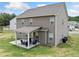 Exterior shot of the home with a covered patio and a large, well-maintained backyard at 31 Village Trce, Rydal, GA 30171