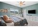 A cozy bedroom with stylish decor, large window, and a view of the neighborhood at 31 Village Trce, Rydal, GA 30171