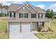Beautiful two-story home with a well-manicured lawn, inviting front porch, and attached two-car garage at 31 Village Trce, Rydal, GA 30171
