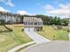 Expansive view of a two-story home with a long driveway and surrounding green landscape at 31 Village Trce, Rydal, GA 30171