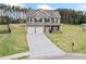 Beautiful two-story home with a long driveway and surrounding green landscape, black fence at 31 Village Trce, Rydal, GA 30171