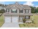 Charming two-story home boasts a welcoming porch, two-car garage, and beautiful curb appeal at 31 Village Trce, Rydal, GA 30171