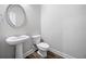 Half bathroom with pedestal sink and modern fixtures at 31 Village Trce, Rydal, GA 30171