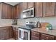 Modern kitchen features stainless steel appliances, granite countertops, and dark wood cabinets at 31 Village Trce, Rydal, GA 30171