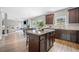 Open-concept kitchen with a center island, modern appliances, and seamless flow to the living area at 31 Village Trce, Rydal, GA 30171