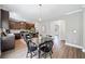 Bright, open kitchen and dining area with dark wood cabinets and modern appliances at 31 Village Trce, Rydal, GA 30171