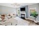 Comfortable living room with fireplace, large windows, and hardwood floors at 31 Village Trce, Rydal, GA 30171