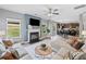 Bright living room with fireplace, large windows, and view into the kitchen and dining area at 31 Village Trce, Rydal, GA 30171